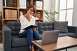© Krakenimages.com - Young beautiful hispanic woman psychologist writing on document using laptop at psychology clinic