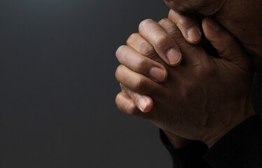 Poster - man praying to god with hands together Caribbean man praying with white background stock photo	