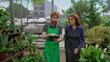 © Marco - Redhaired Employees Utilizing Tablet to Showcase Inventory at Local Plant Shop. Male Staff Assisting Female Colleague during Store Walkthrough
