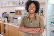 © Brastock Images - portrait of a coffee shop owner in Brazil with her arms crossed smiling at the camera