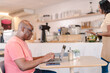 © Nexa - black Brazilian man using his laptop computer to access the internet in a coffee shop in Brazil