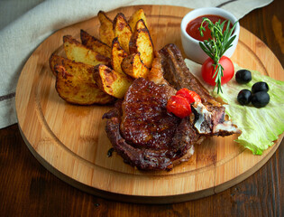 Wall Mural - Grilled beef steak with baked potatoes and vegetables on plate