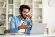 © Prostock-studio - Web Conference. Handsome Indian Man In Headset Making Video Call Via Laptop