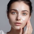 © Valua Vitaly - Beautiful young woman with cream on face. Skin care concept.  Skincare. Portrait of beautiful Caucasian woman with cosmetics moisturizer cream on face. Beauty and  healthy skin concept.  AI generated