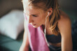 Young woman resting at home after having a workout in the morning