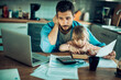 © Geber86 - Single father going over the bills with his daughter in the lap