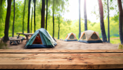 wood table and blurred camping and tents in forest.