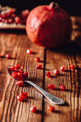 Sticker - Pomegranate Seeds in Vintage Spoon. and Fruit on Backdrop.