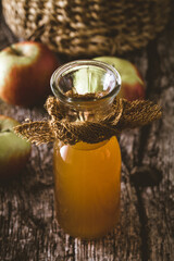 Canvas Print - Apple vinegar. Bottle of apple organic vinegar on wooden background. Healthy organic food.