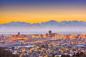 Sticker - Toyama City, Japan downtown skyline with background mountains at dawn.