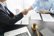© Pichsakul - Lawyer and legal concept, Businessman and senior lawyer shake hands after successful deal contract