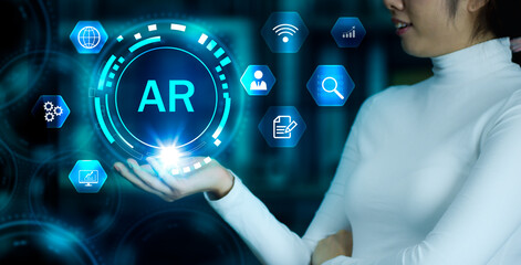 Poster - Woman in long sleeve t shirt holding virtual screen AR icon blue neon light color. Technology concept.