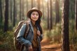 © sirisakboakaew - Beautiful Asian backpacker traveling alone in the forest. Attractive young female tourist looks around and explores while walking in the natural forest with joy and fun during holiday trip.
