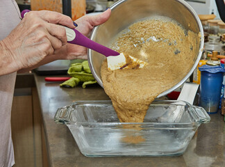 Canvas Print - Chef pours the mass for making Casserole from eggplant and zucchini in two colors into the mold