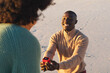 © wavebreak3 - Happy african american man kneeling with ring and proposing to girlfriend on sunny beach
