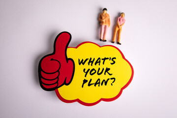 Wall Mural - What's Your Plan. Sticky note with text and miniature human figures on a white background