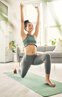 Yoga, lunge and woman at home with zen, relax and leg stretching for health in a living room. Young female person, apartment and lounge with pilates and flexibility exercise in house feeling calm