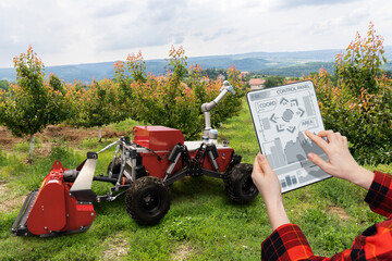 Sticker - Farmer controls autonomous robot in a fruit garden. Smart farming concept.