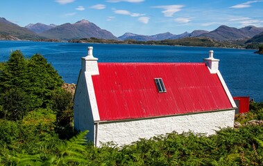 Canvas Print - Idyllic scene of a quaint cottage situated lakeside in the Scottish Highlands