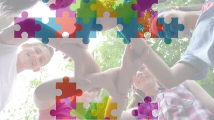 Poster - Animation of multicolored puzzle pieces, diverse children holding hands and forming abstract symbol