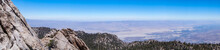 Scenic Aerial Vistas Of Coachella Valley Seen From The Top Of Palm Springs Tramway Station In Mt. San Jacinto State Park, California, USA. View On Mountain Landscape And Canyons. Trees In Foreground