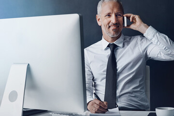 Wall Mural - Online communication, mature businessman on a phone call and against studio background with computer at desk, Happy or connectivity, social networking or crm and male person with smartphone planning