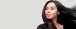 © AMK  - Charming Asian teenager with long hair blowing in the breeze exudes positivity with a bright smile on a white background.