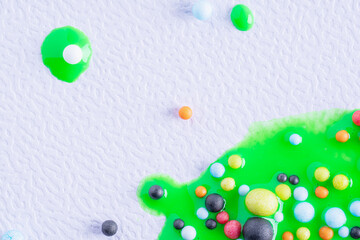 Wall Mural - Balls in green paint on white canvas. Abstract colorful background. Background with colorful balls in different sizes and paints. Arts background