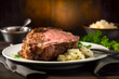Delicious roasted medium rare prime rib on a plate served with mashed potatoes. Traditional American cuisine holiday food concept