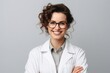 © igolaizola - Portrait of smiling female doctor in eyeglasses, isolated on grey