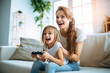 Mother and daughter laugh and play video games together. Generative AI