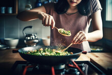 Woman Preparing Asian Food In Wok Pan At Home, Close Up