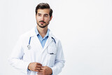 Fototapeta Na drzwi - Man doctor in a white coat with a stethoscope smile with teeth and good test results looking into the camera on a white isolated background, copy space, space for text, health