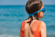 Child with sunburned skin at a beach