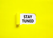 Stay tuned symbol. Concept words Stay tuned on beautiful white paper on a beautiful yellow background. Business, support, motivation, psychological and stay tuned concept. Copy space.