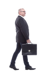 side view. a business man with a leather briefcase striding forward