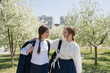 © ADDICTIVE STOCK - Happy teenage school going girls walking on pathway