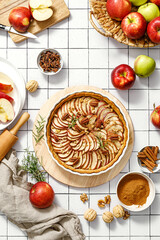 Wall Mural - Apple pie. Apple tart with cinnamon, walnuts and pecan nuts, top view