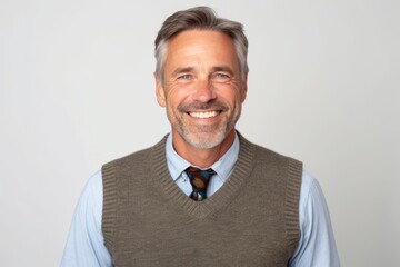 Portrait of a handsome middle-aged man smiling against white background