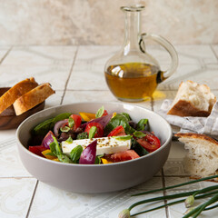 Wall Mural - bowl with traditional greek horiatiki salad on light table