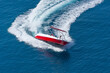 Aerial drone top boat making extreme manoeuvres in Mediterranean bay with deep blue sea.