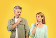 © Prostock-studio - Shh, keep silence. Middle aged european couple gesturing hush sign, looking at each other and holding finger on lips