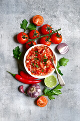 Wall Mural - Tomato salsa (salsa roja) - traditional mexican sauce  with ingredients for making .Top view with copy space.