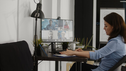 Poster - Business woman using online videocall to talk to people, attending telework briefing meeting on videoconference. Professional manager talking to colleagues on remote internet videoconference.