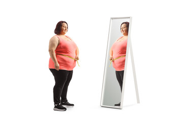 Poster - Young overweight woman measuring her waist in front of a mirror