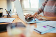 © Geber86 - Young woman working from home on her laptop