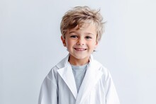 Portrait Of Smiling Little Boy In Lab Coat Isolated On Grey Background