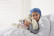 © New Africa - Childhood cancer. Girl with toy bunny in hospital