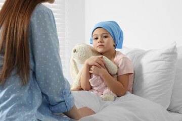 Canvas Print - Childhood cancer. Mother and daughter with toy bunny in hospital