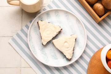 Plate of tasty sandwiches with cream cheese on white tile background